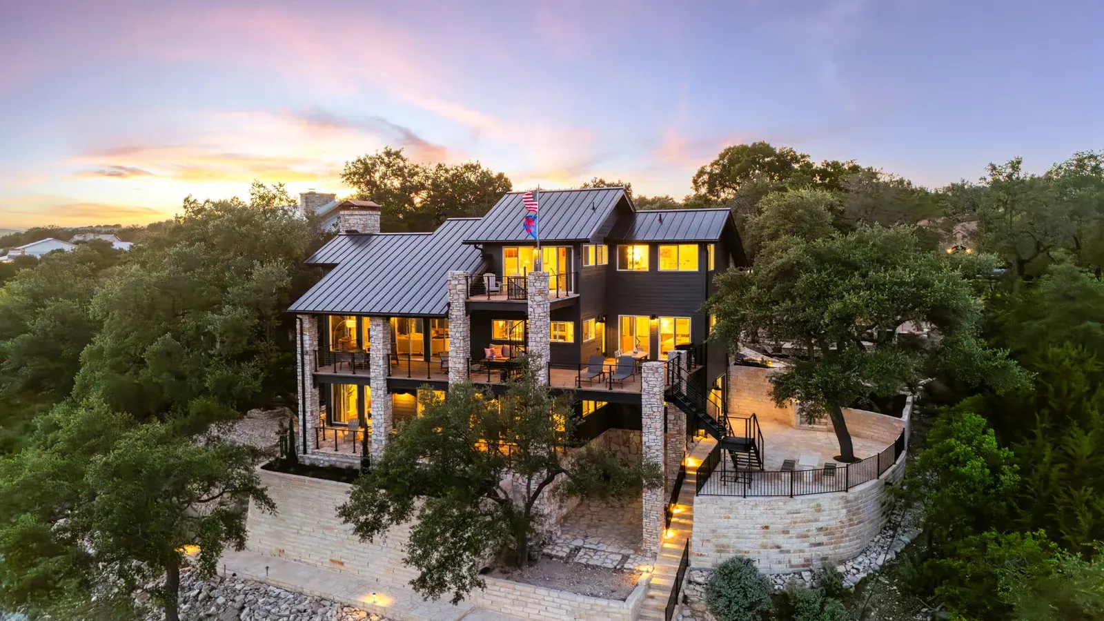 Exterior hill country stone house at sunset in Lago Vista, TX